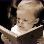 A child with glasses reading a book